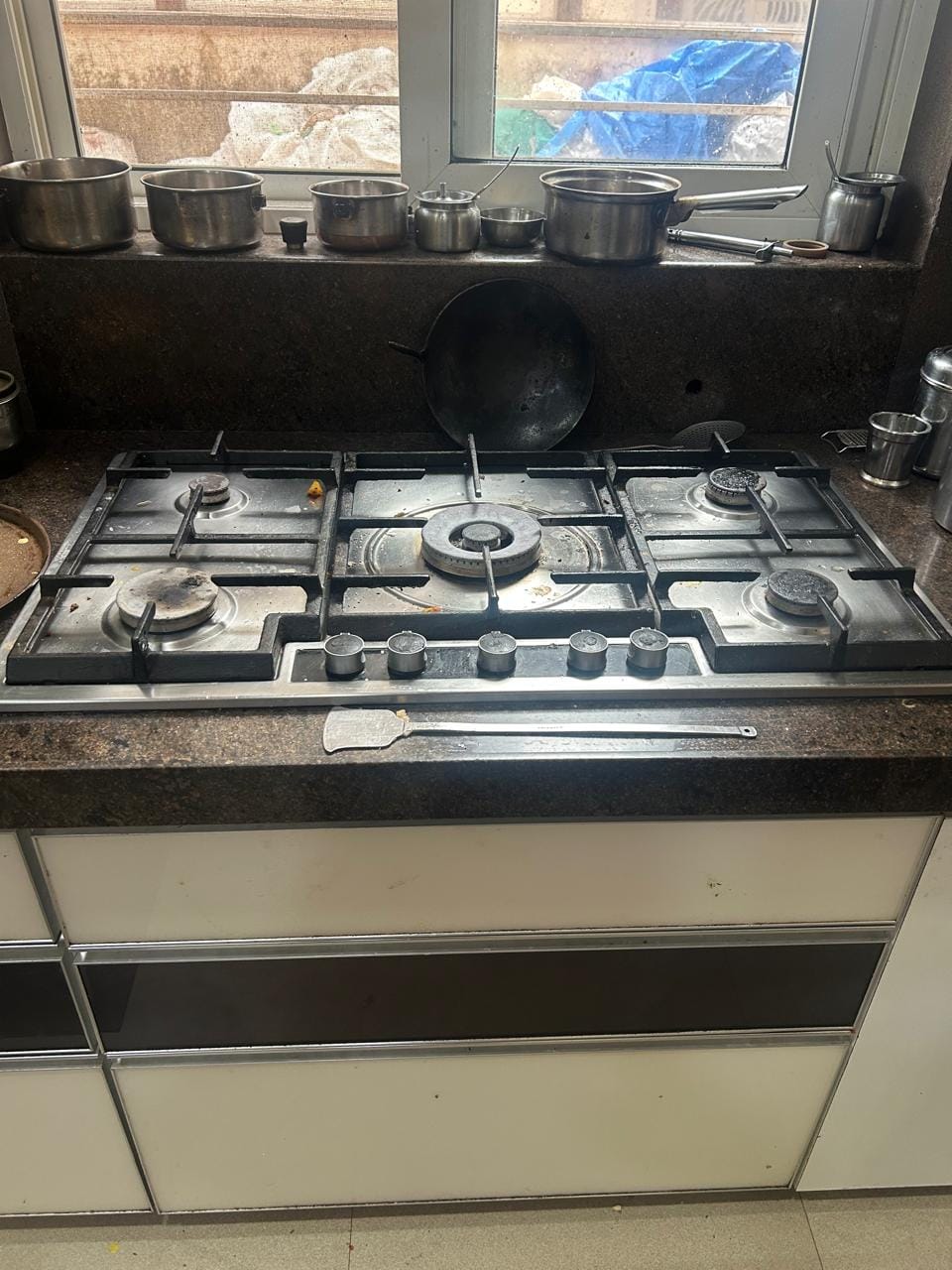 Cooking range servicing by technician